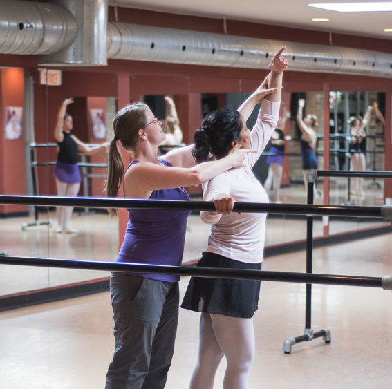 Ballet teacher helping a student